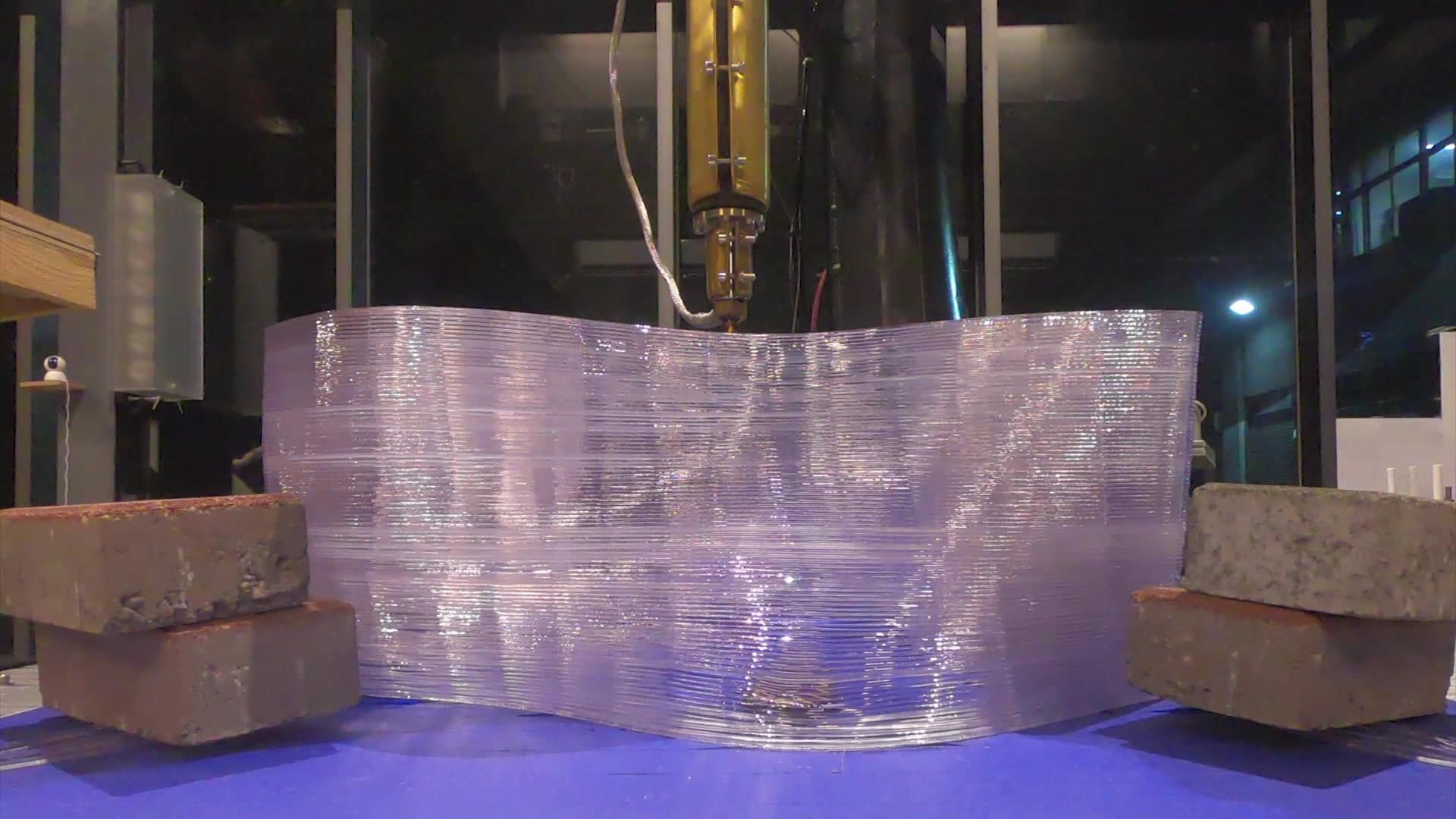 Full-scale translucent printed module held in the robotic fabrication setup.