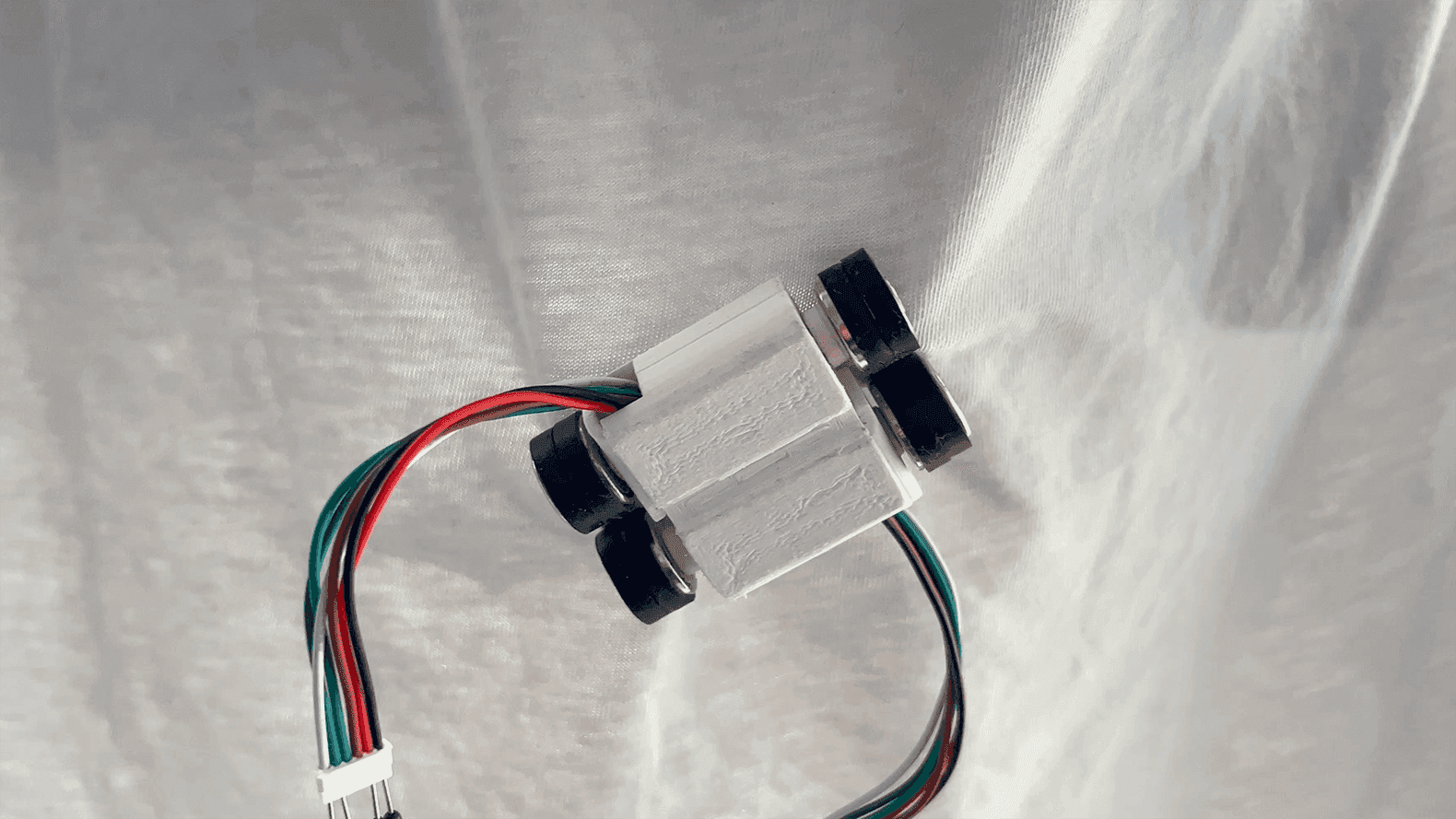Close-up of the Climber 3D-printed robot gripping fabric.